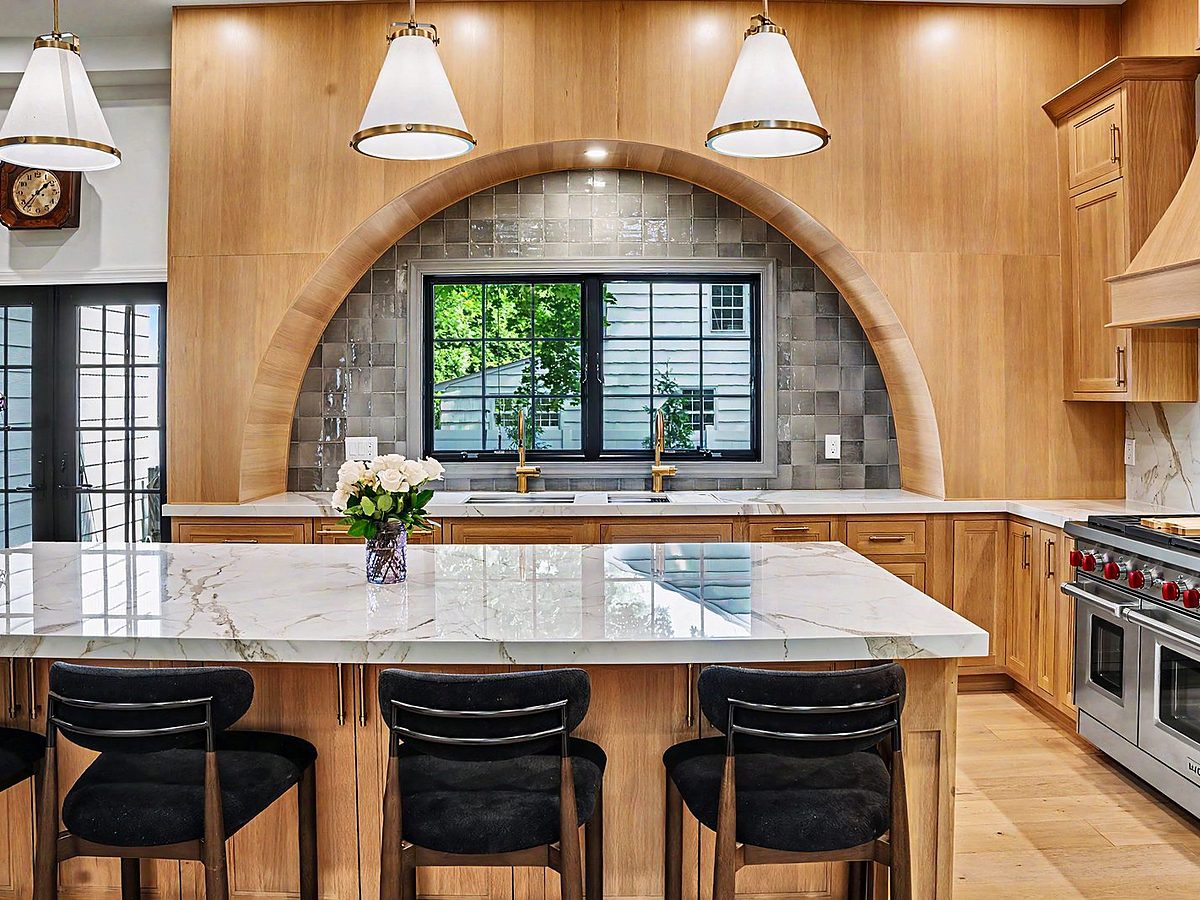Shiloh flush-inset rift white oak kitchen with an arched range niche