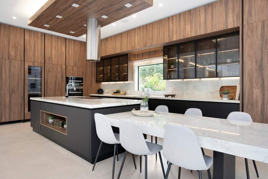 Adornus wood-tone slab kitchen with a marble-look island — manufacturer photo