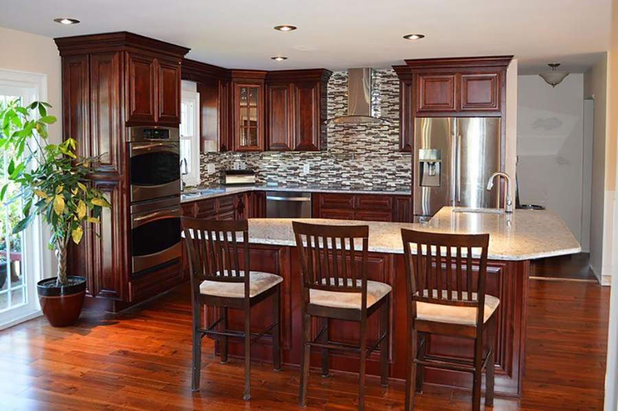 21st Century Sedona mahogany-tone kitchen with a breakfast bar — manufacturer photo