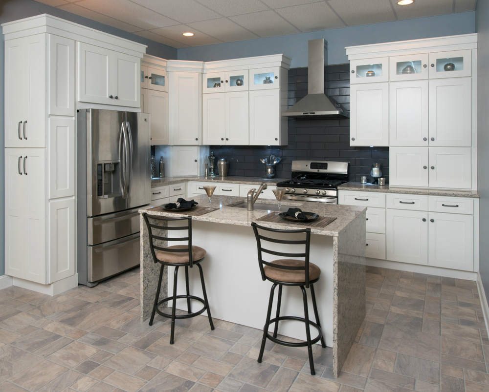 FGM white shaker kitchen with a grey island and tile floor — manufacturer photo
