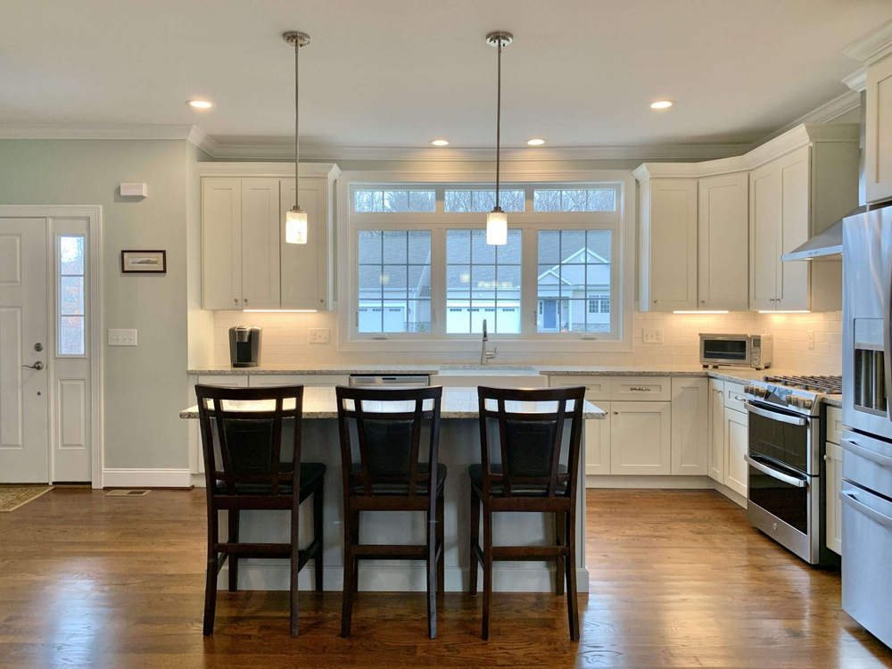 FGM white shaker kitchen with a long island — manufacturer photo