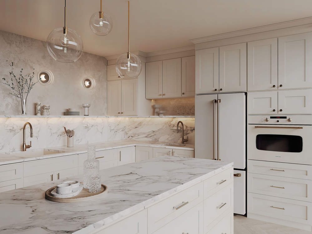 Forevermark white kitchen with marble-look counters and gold hardware — manufacturer photo
