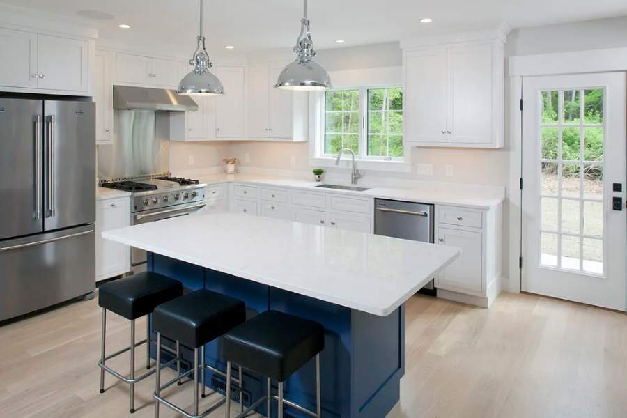 Great Northern inset kitchen in Frosty White on maple with a custom navy island — manufacturer photo