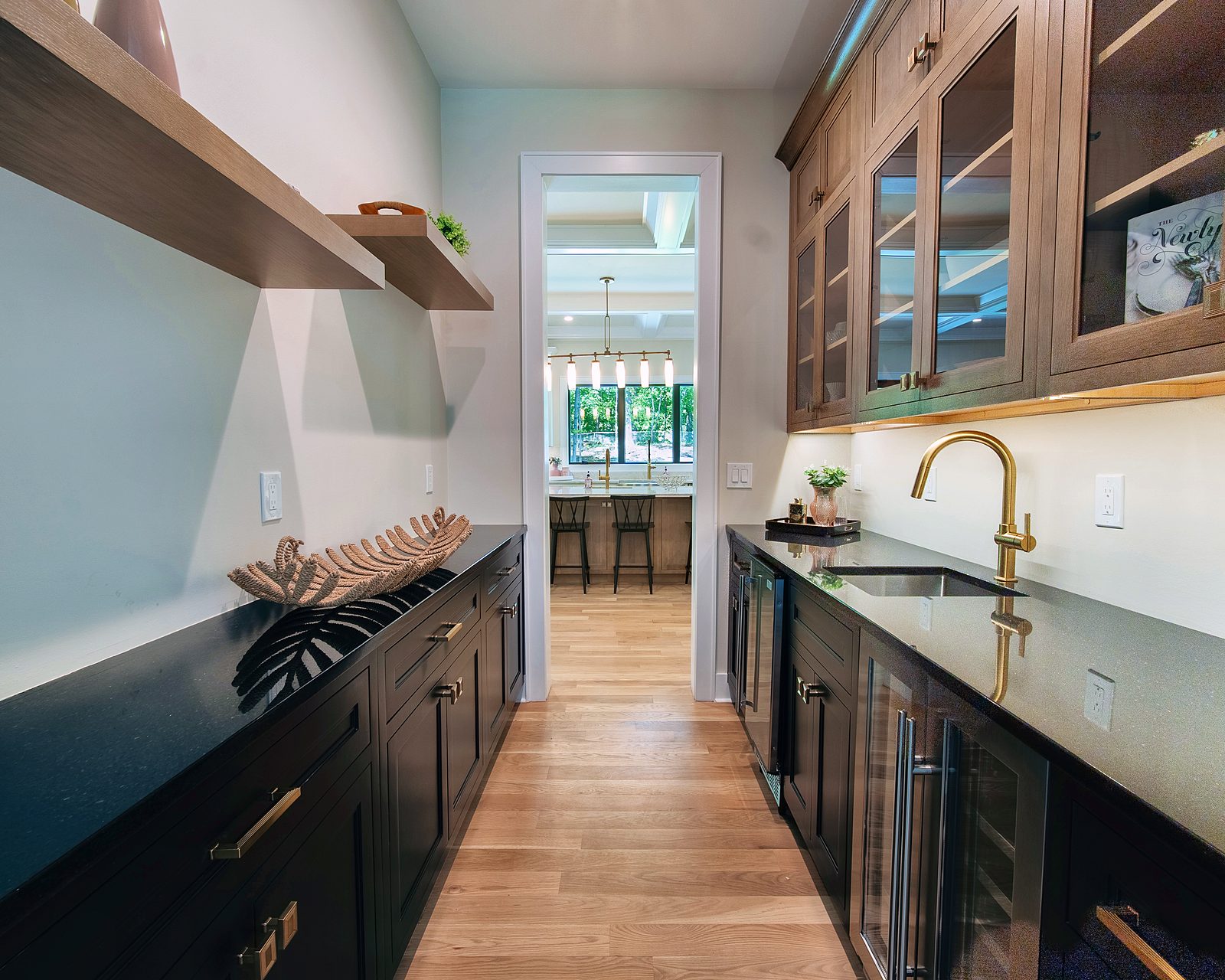 Black butler's pantry with glass uppers and beverage center