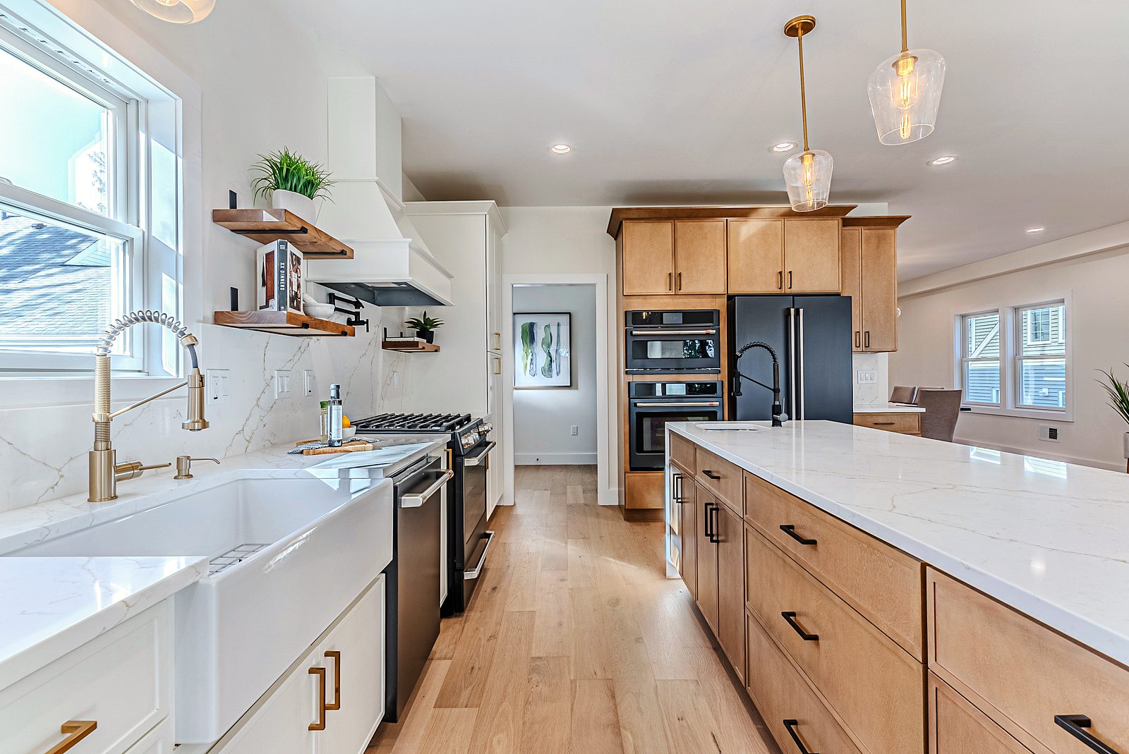 Island and farmhouse sink with brass faucet