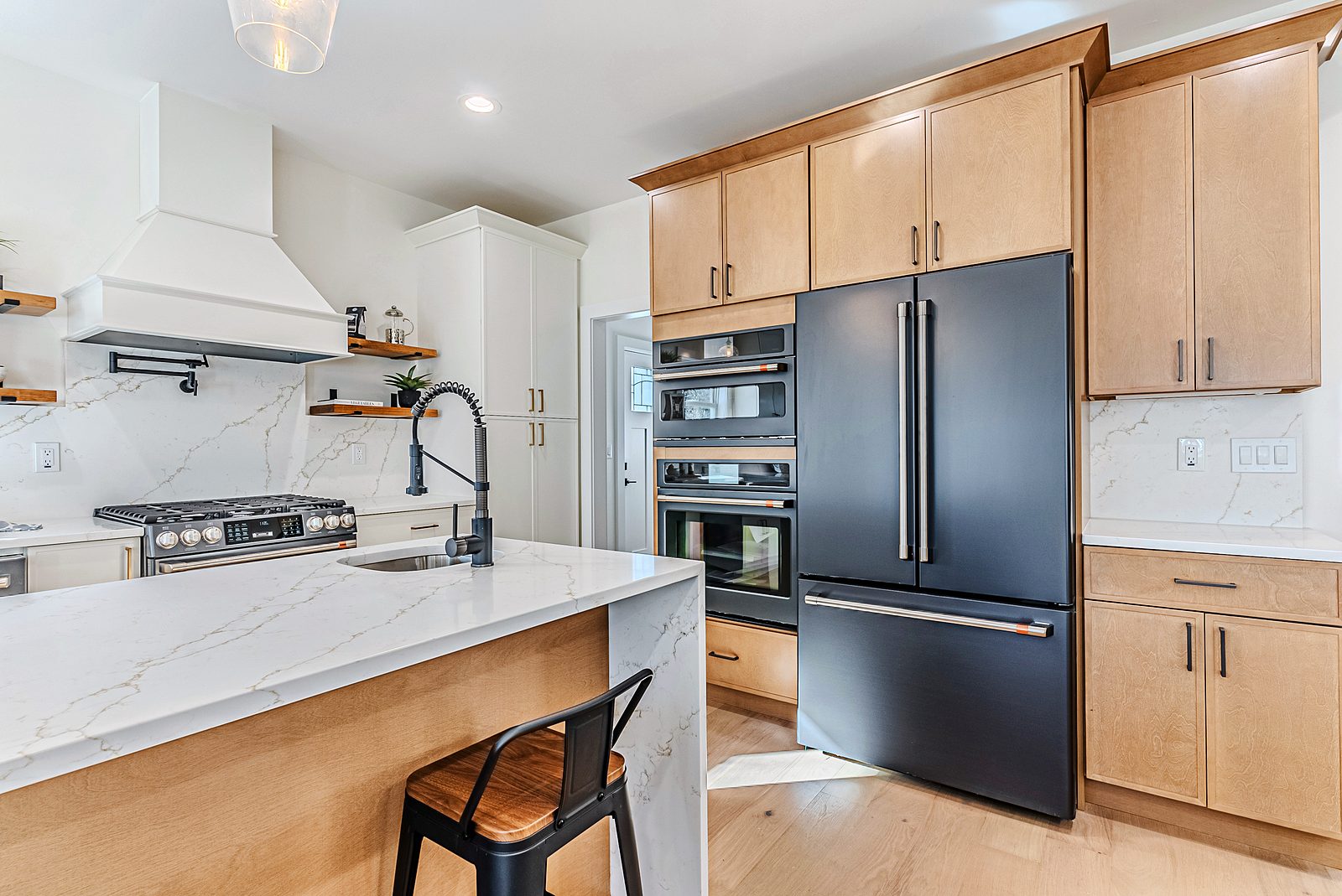 Natural slab pantry wall with Café matte-black refrigerator