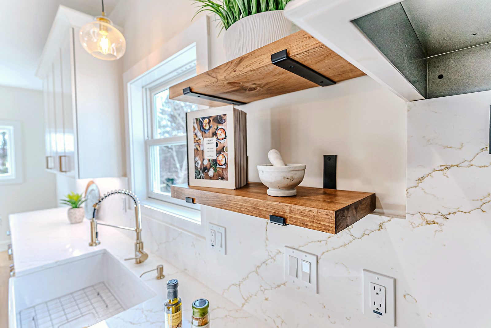 Hood, pot filler and floating shelf detail