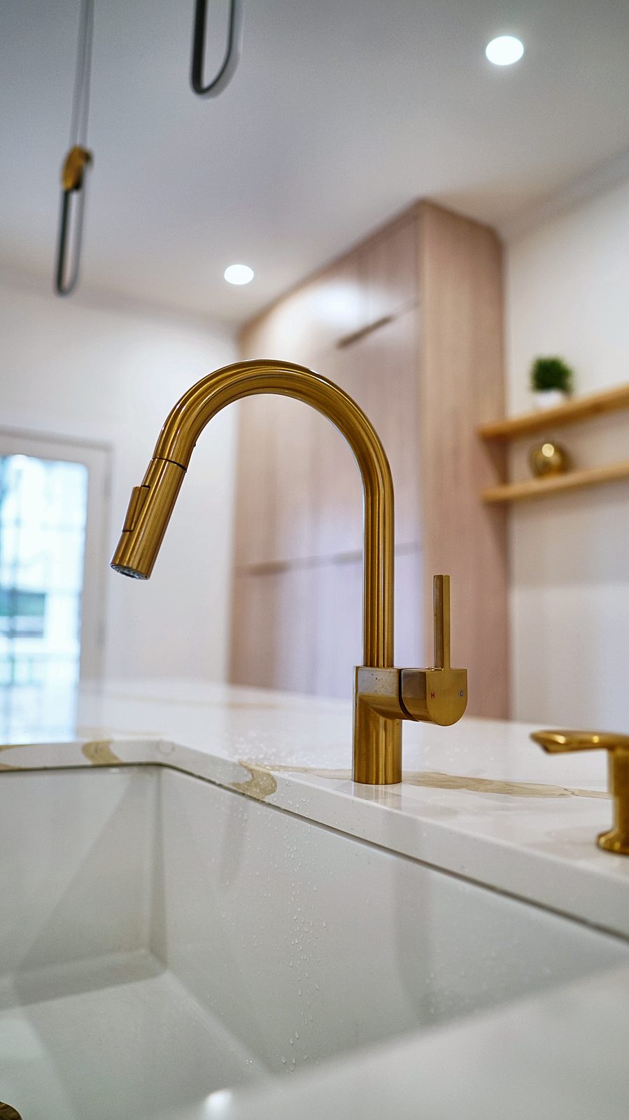 Brass faucet and farmhouse sink detail