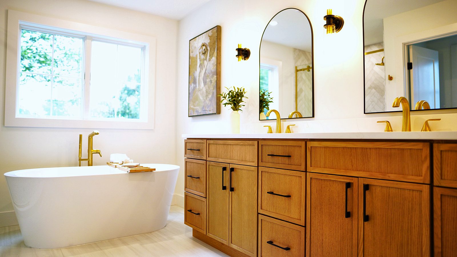 Timber double vanity with arched mirrors and a freestanding tub in Cranford, NJ