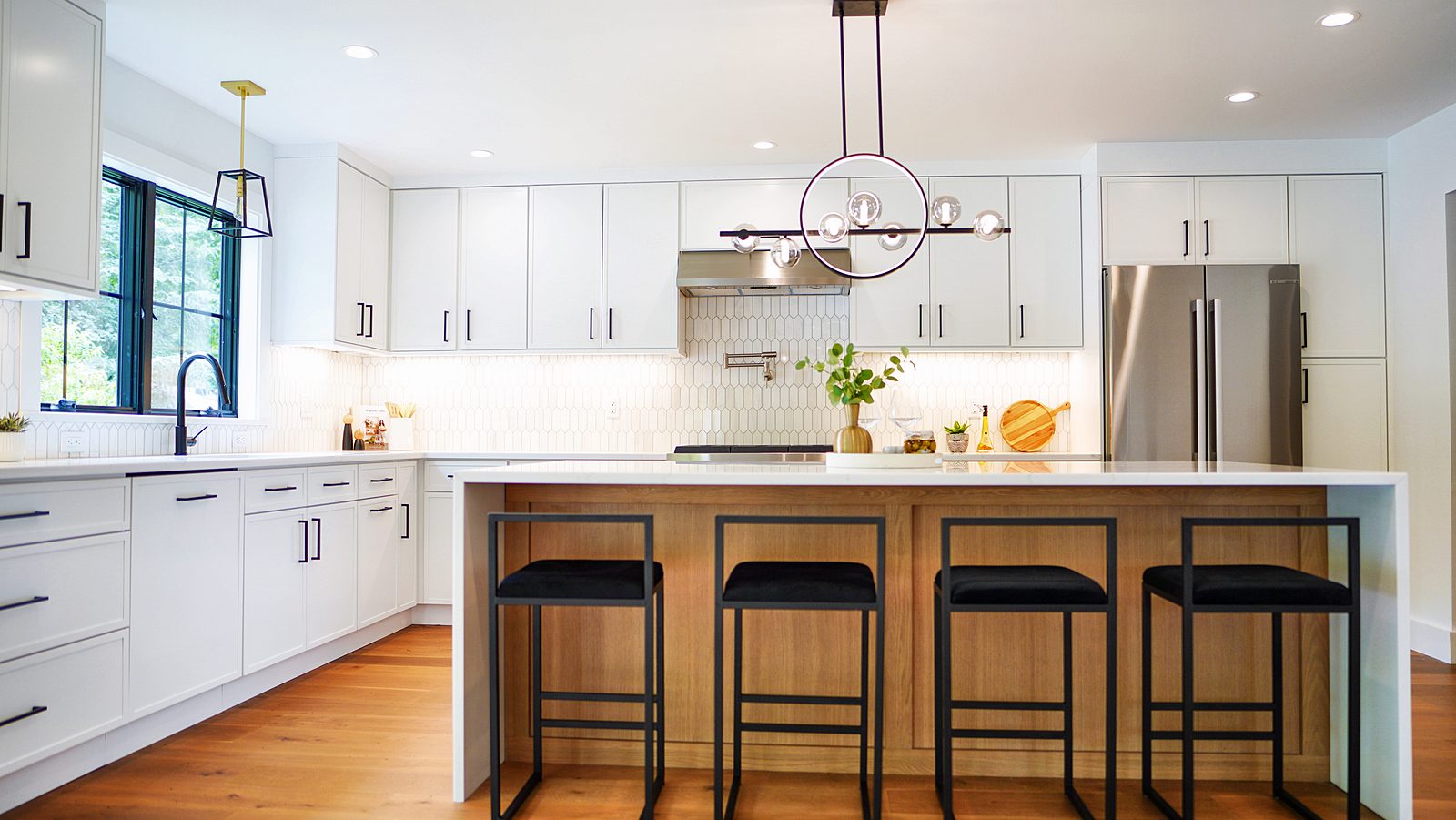 Island seating under the black ring pendant