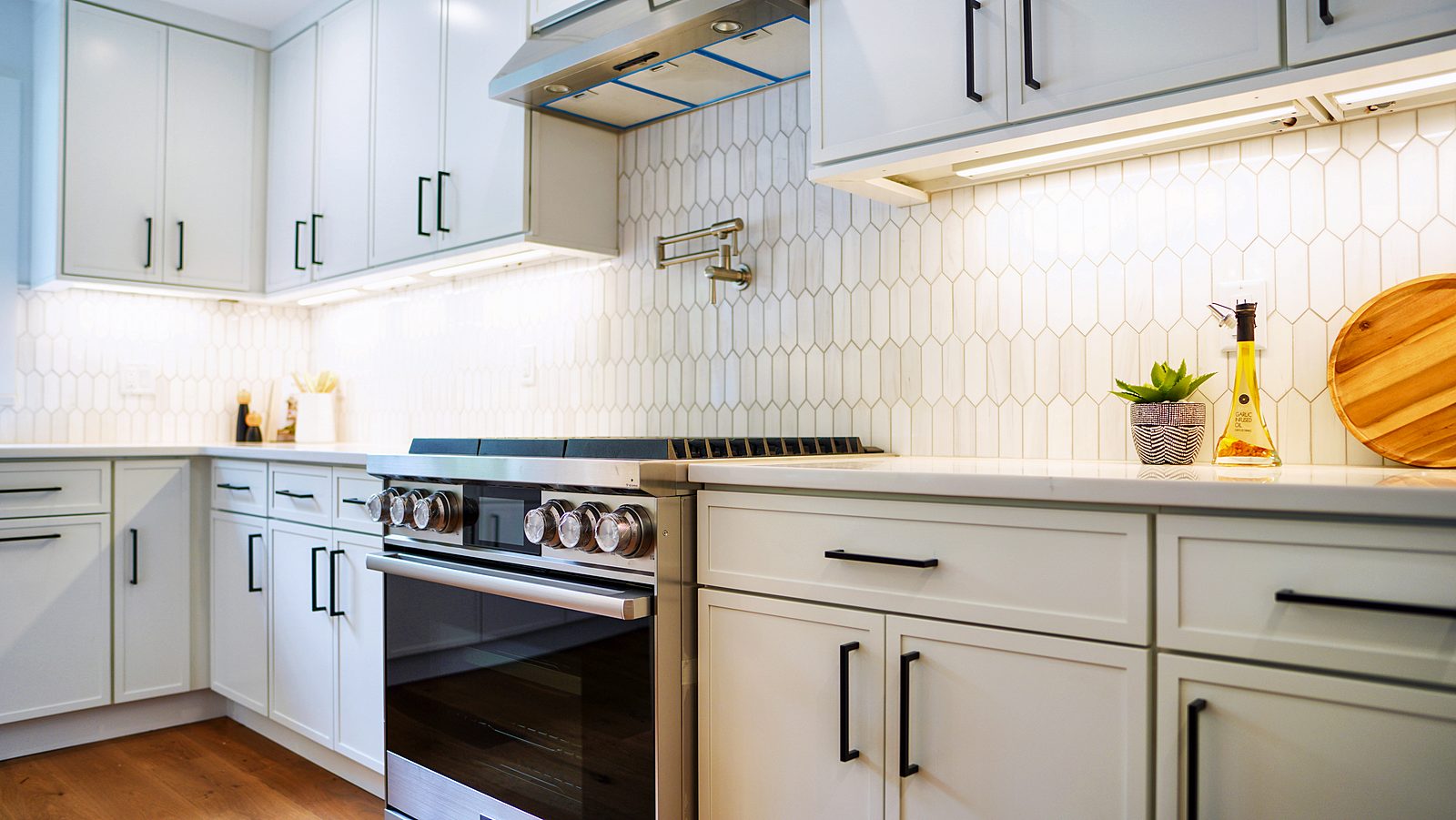Range wall with picket tile and stainless hood