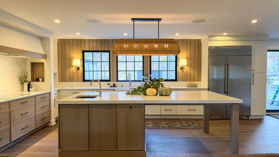 Cream kitchen with a white-oak island, a wood-slat window wall and a sage bar