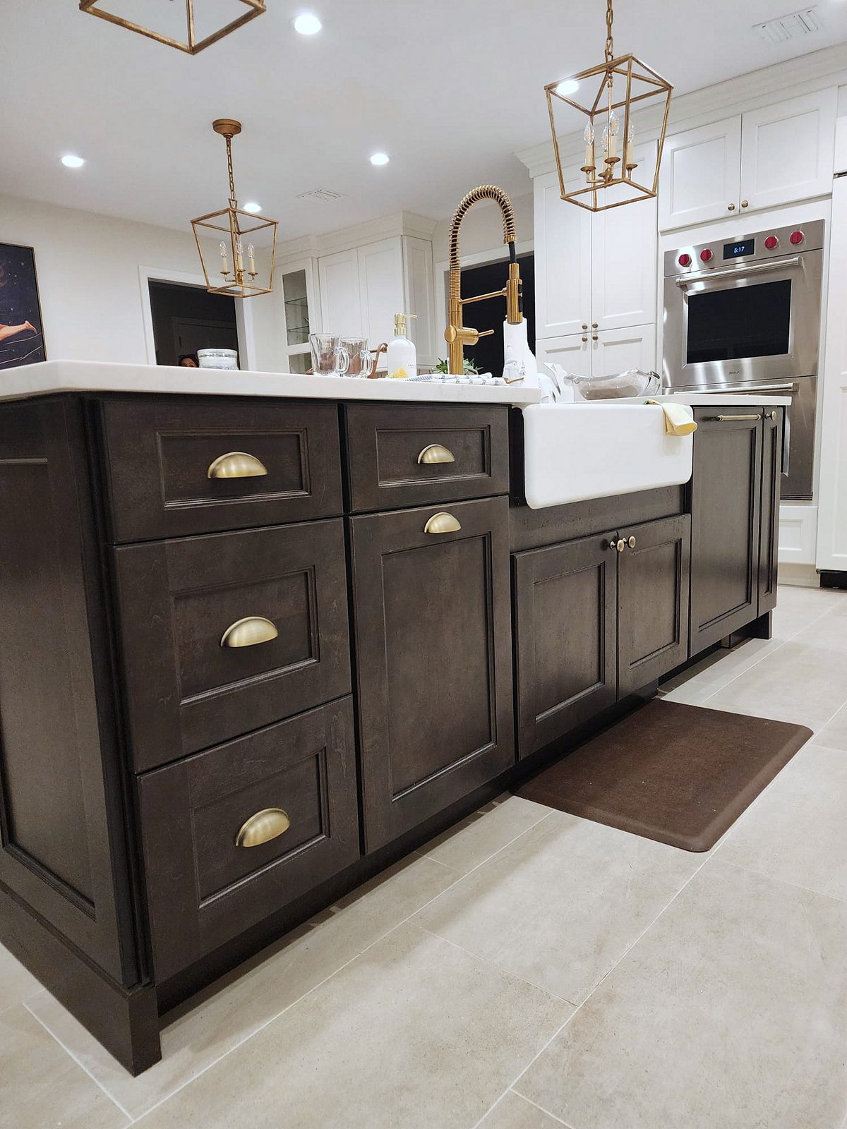 Fabuwood Fusion door, Dove perimeter, Kona island (archive label) — Fabuwood Fusion kitchen in Dove with a Kona island and brass lanterns