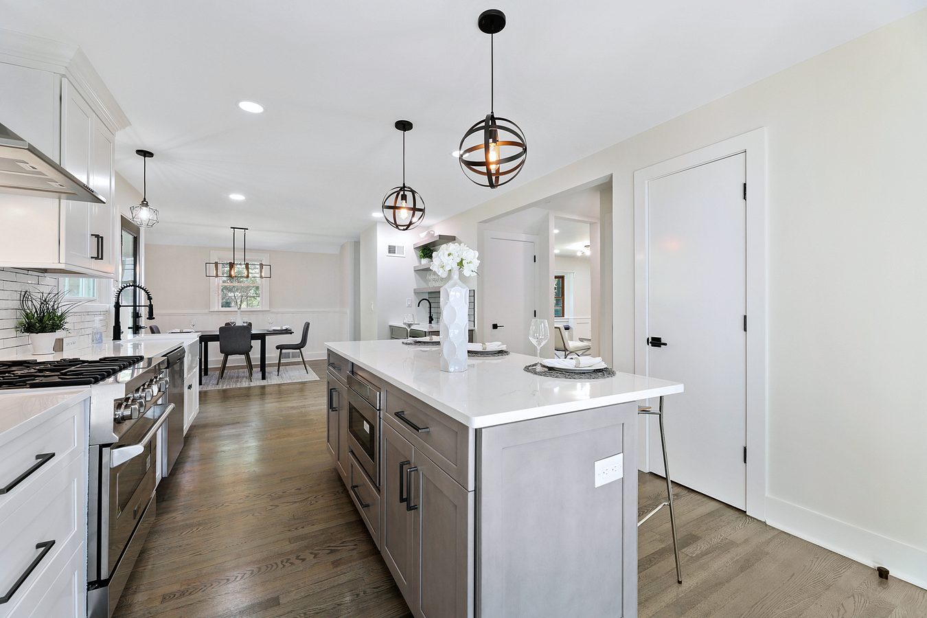 Gray island with a white quartz top — Fabuwood Galaxy in Frost and Horizon with a wine fridge