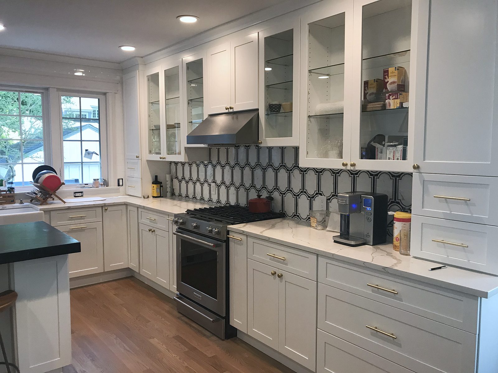 Dark honed island top with a built-up edge — Fabuwood Galaxy in Frost with a dark honed counter and hex tile
