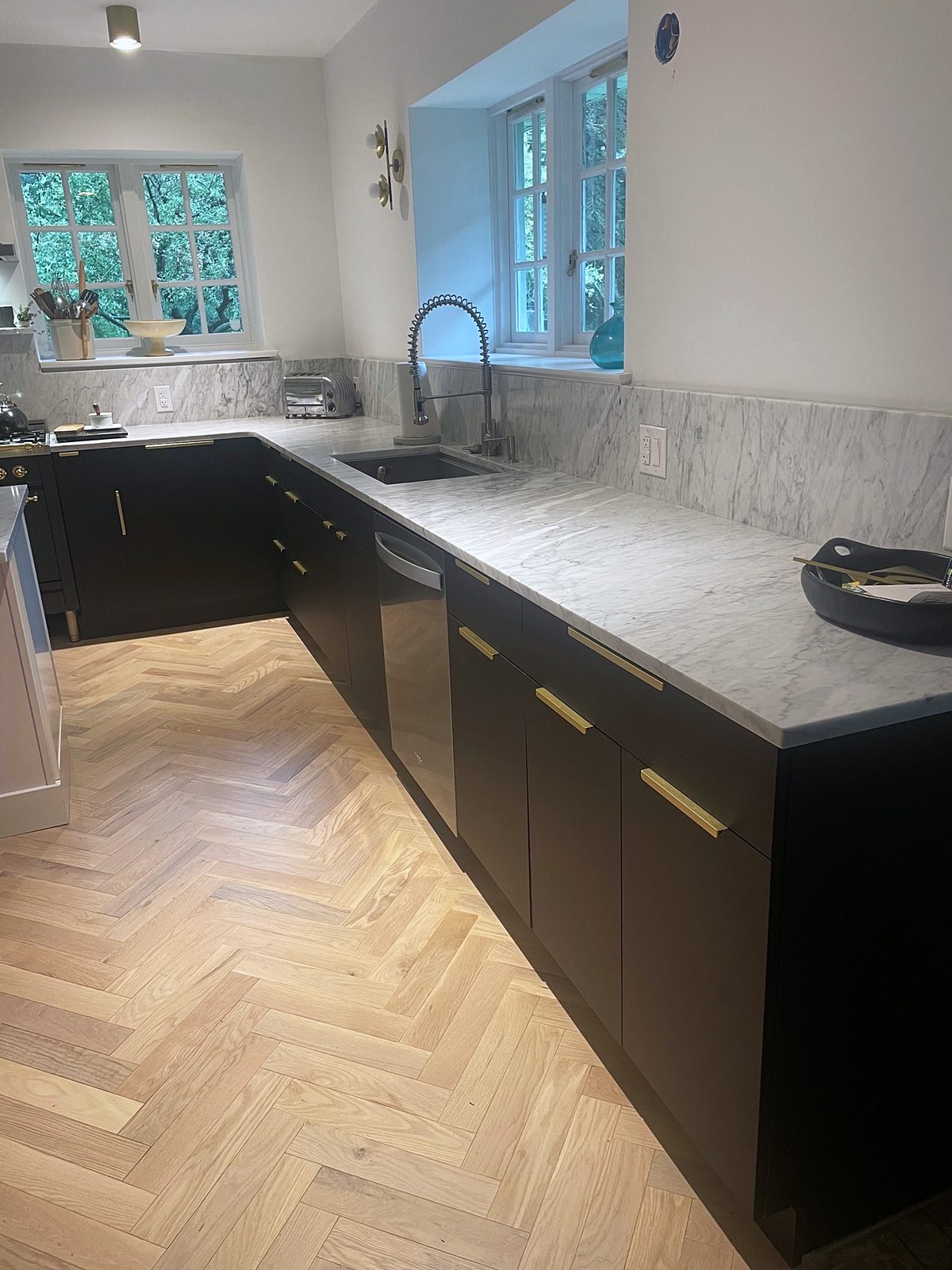 Fabuwood Luna kitchen in matte black with a Dove island and a herringbone floor — photo 7