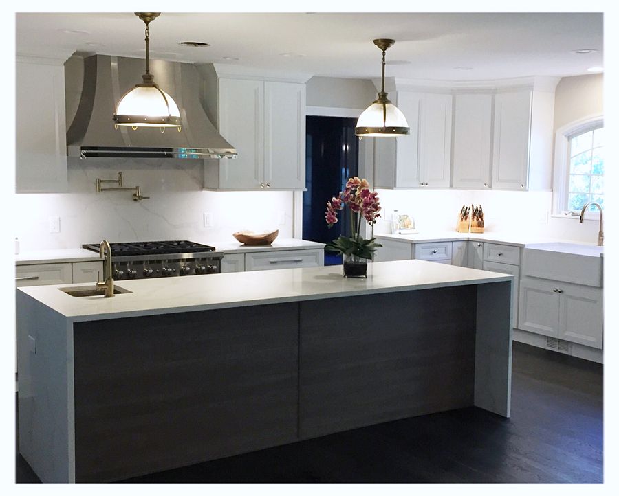 Fabuwood Onyx Frost kitchen with a Cobblestone island and brass dome pendants