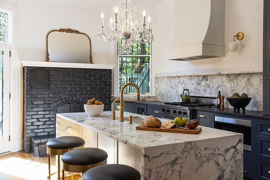 Navy inset kitchen with a marble waterfall island, with Alicja Crosby Interiors