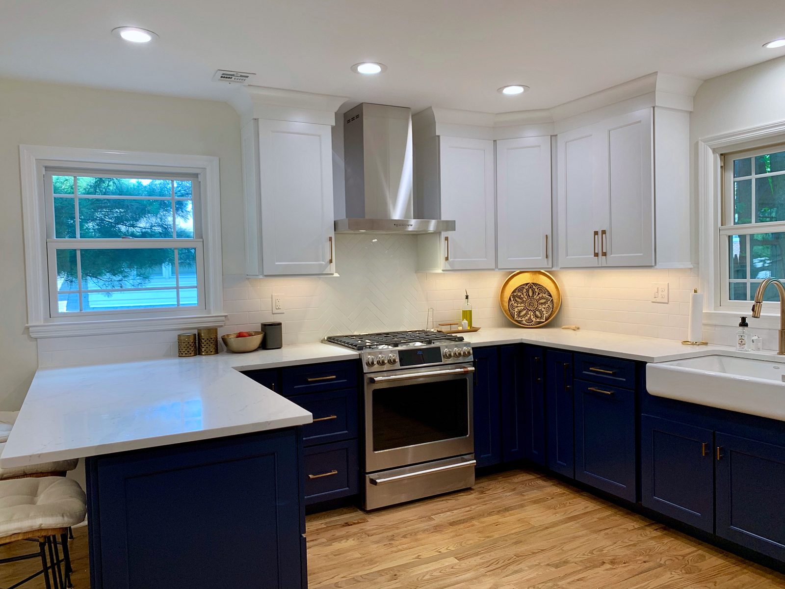 Kith Homestead door, Bright White uppers, Naval base and island (archive label) — Kith Homestead kitchen in Bright White and Naval with Cashmere Carrara quartz