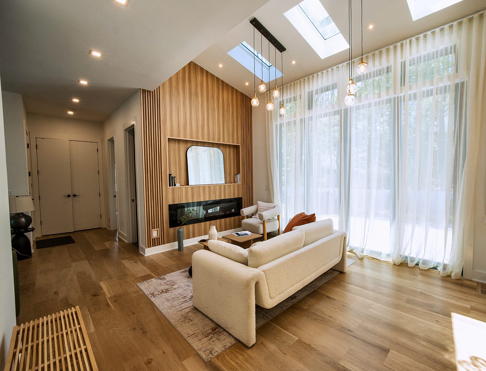 Fluted oak media wall with linear fireplace