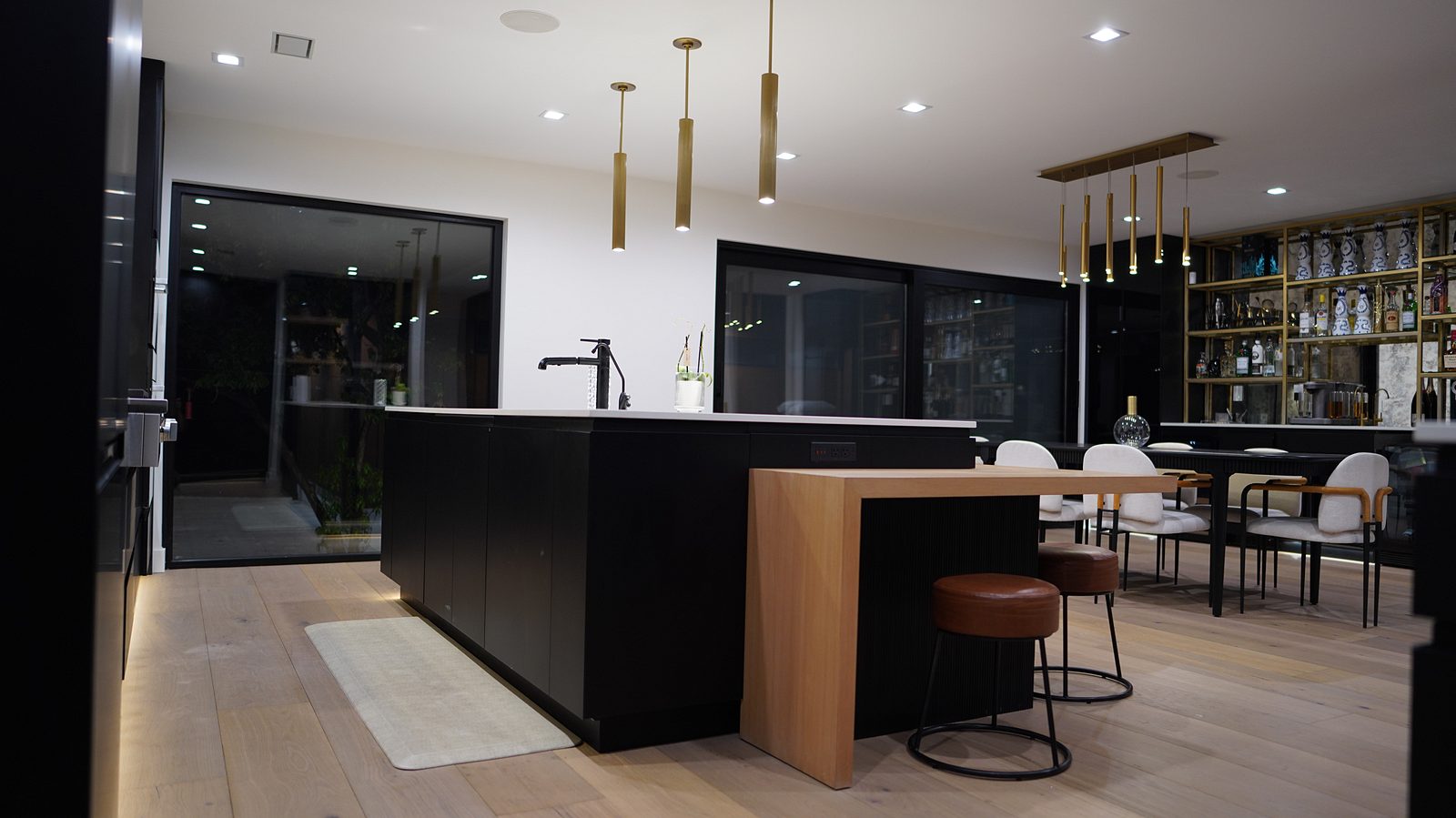 Island seen from the dining side with the slim brass pendants