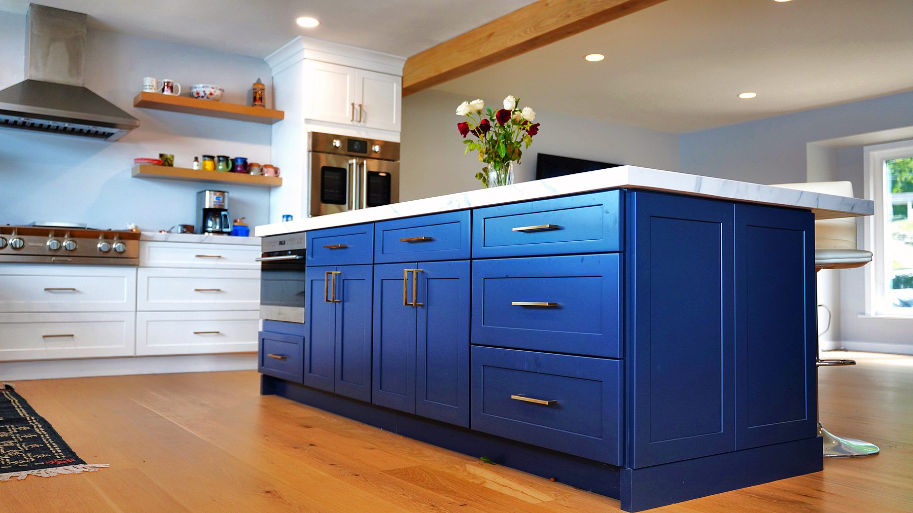 Navy island in a white shaker lake-house kitchen