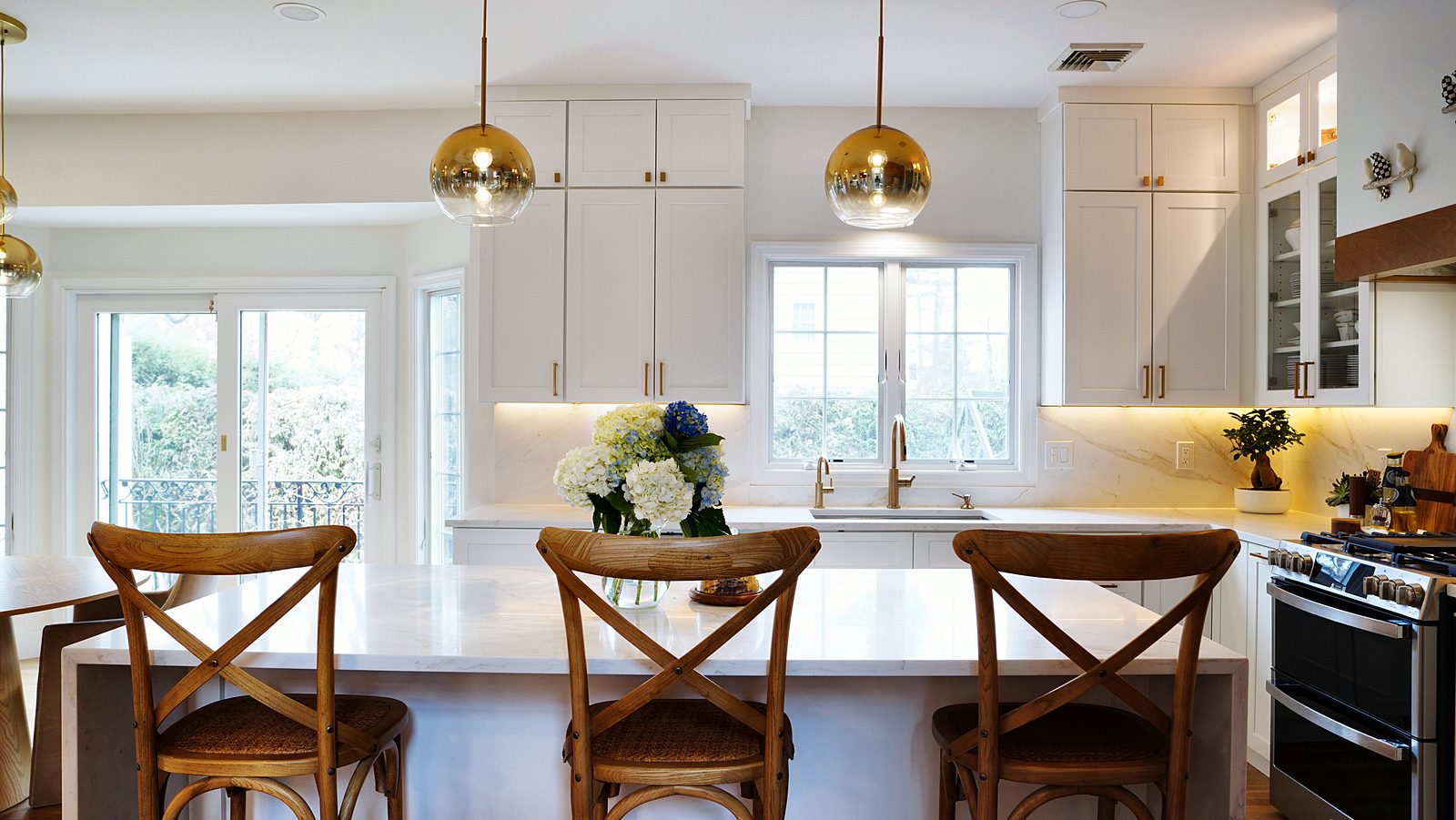 Island seating with pendants and windows beyond