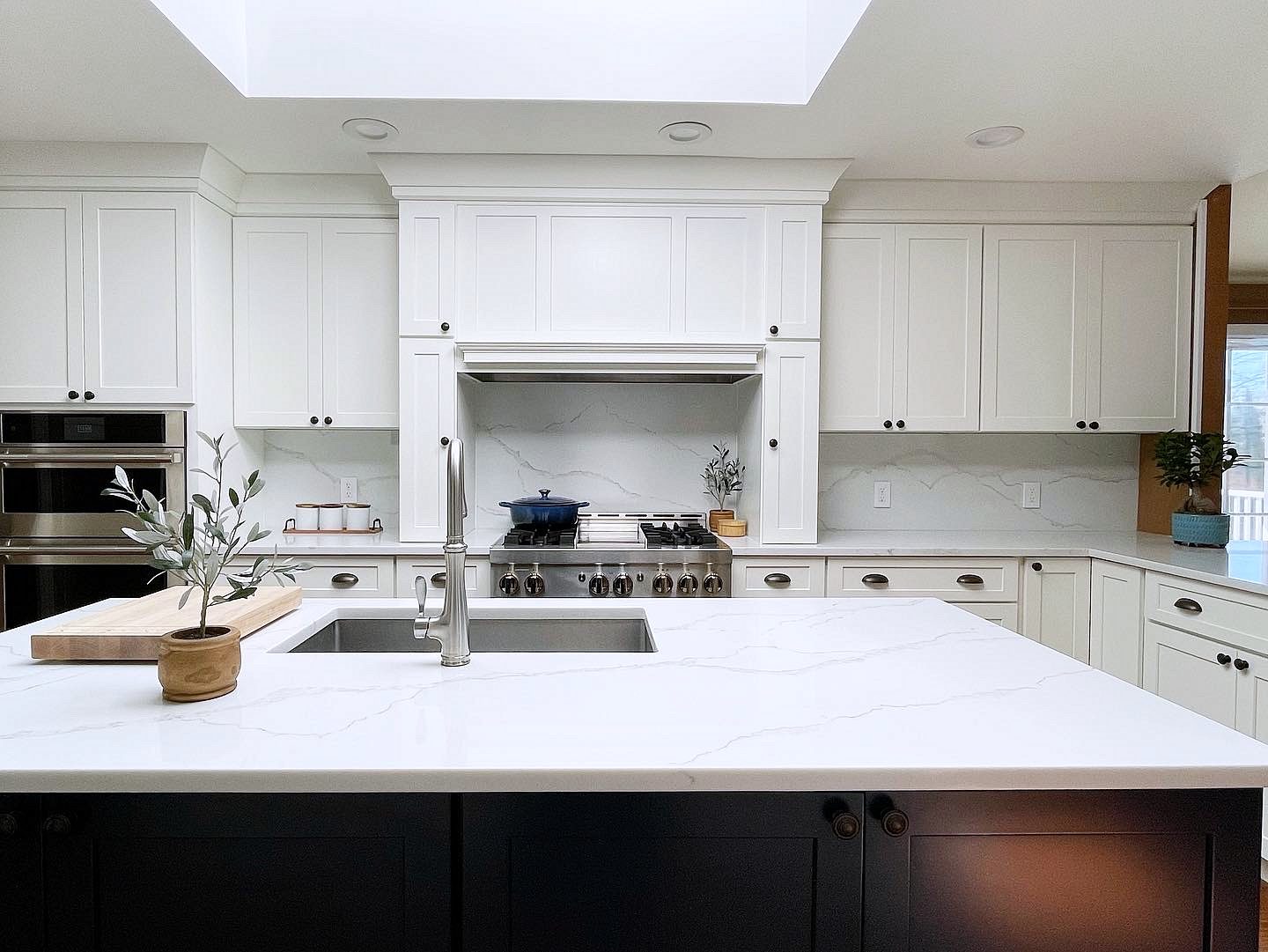 Shiloh Hanover door, Aspen perimeter, black island (archive label) — Shiloh Hanover kitchen in Aspen with a black island and a skylight