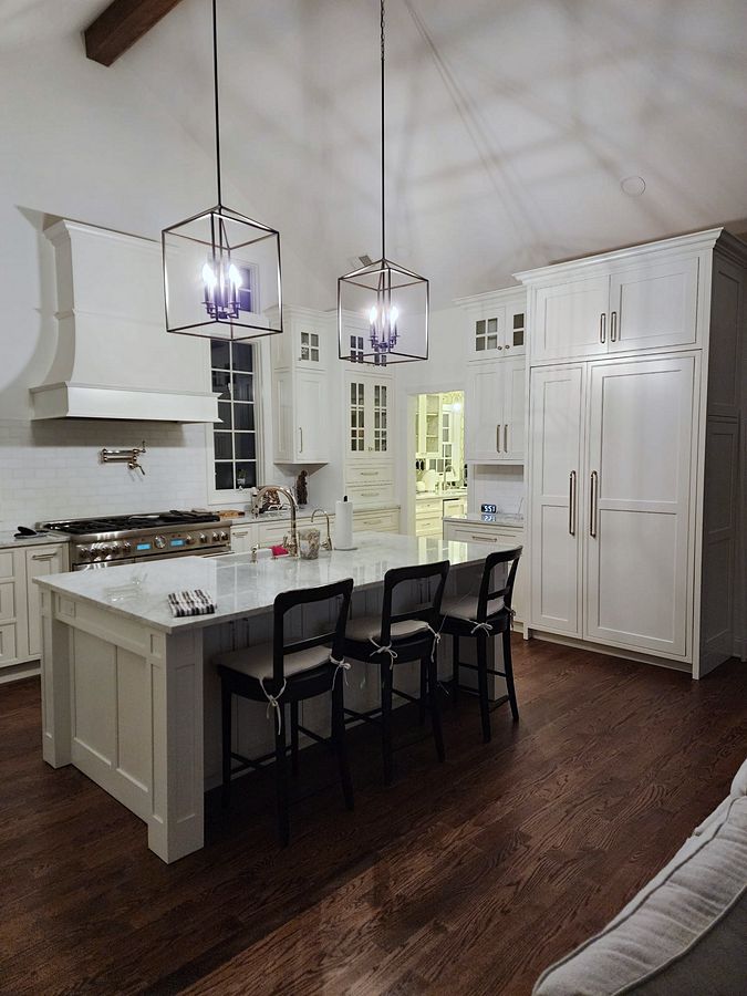 Shiloh Heritage beaded-inset kitchen under a vaulted ceiling with a curved hood
