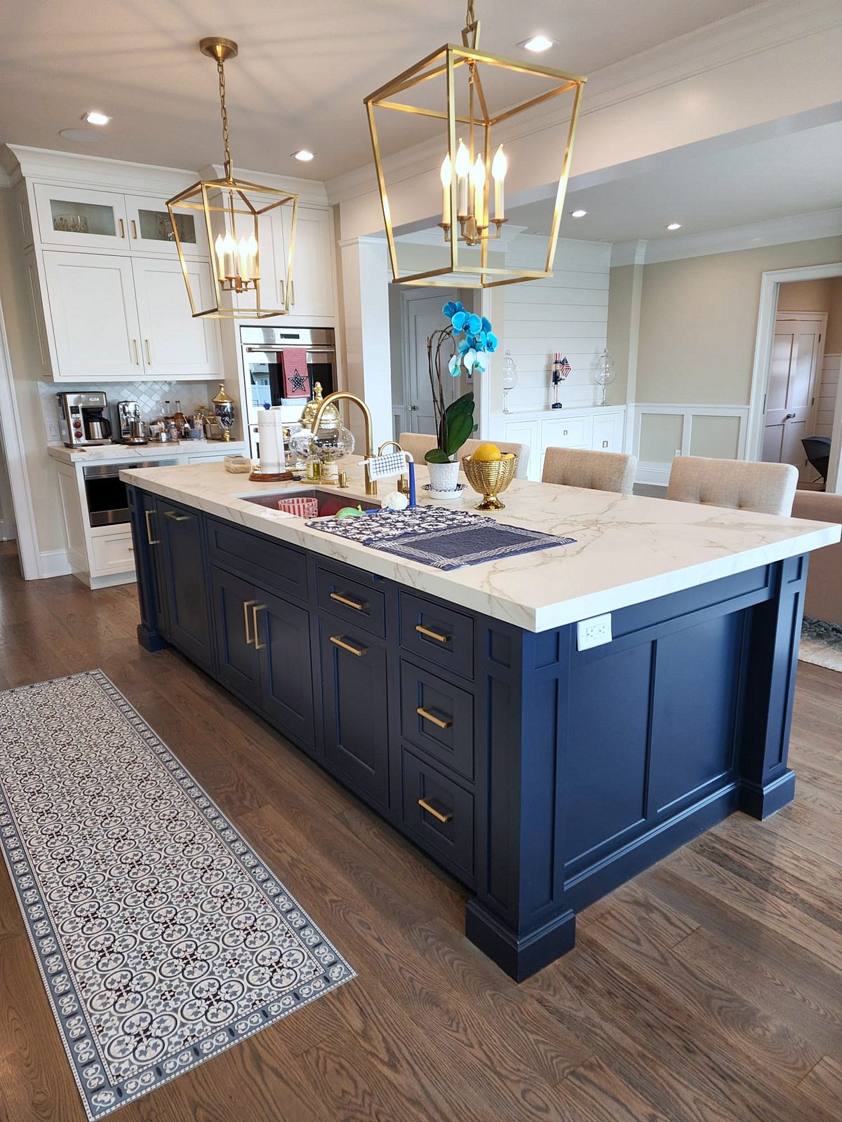 Brass lantern pendants — Shiloh inset kitchen with stacked white uppers and a navy island