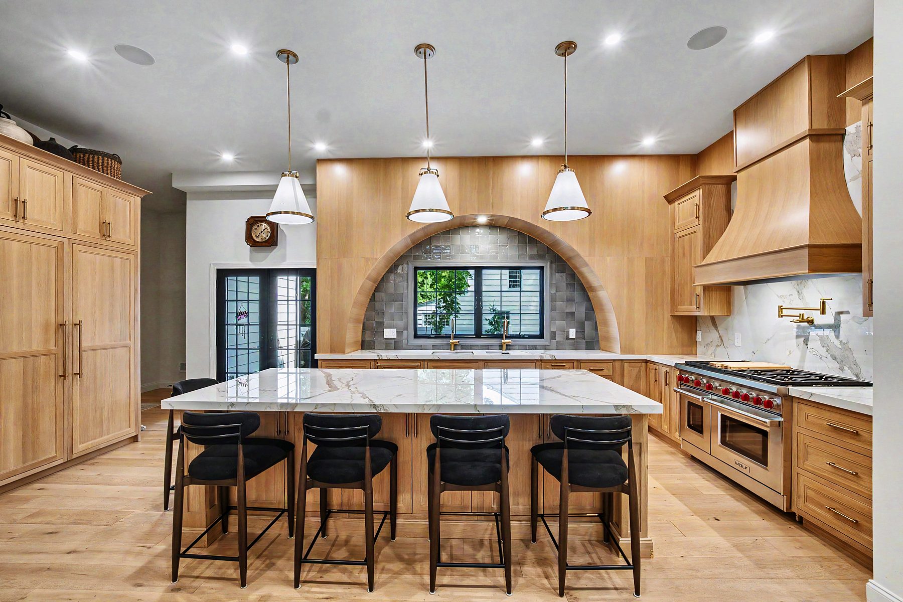 Rift white oak kitchen with an arched niche, Calacatta island and Wolf range — installed in New Jersey by My House Kitchen