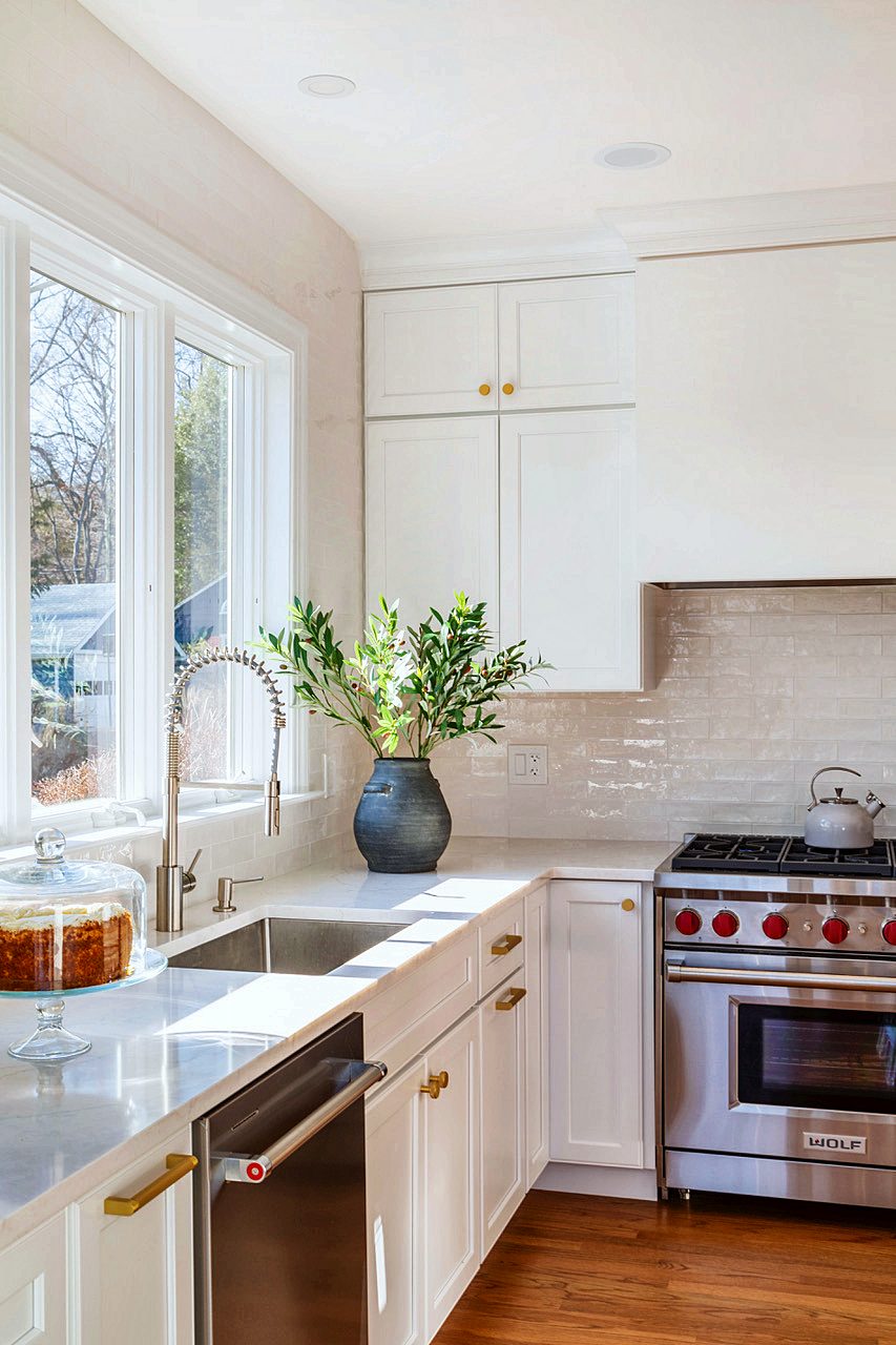 White Shiloh kitchen with Wolf range and brass pendants