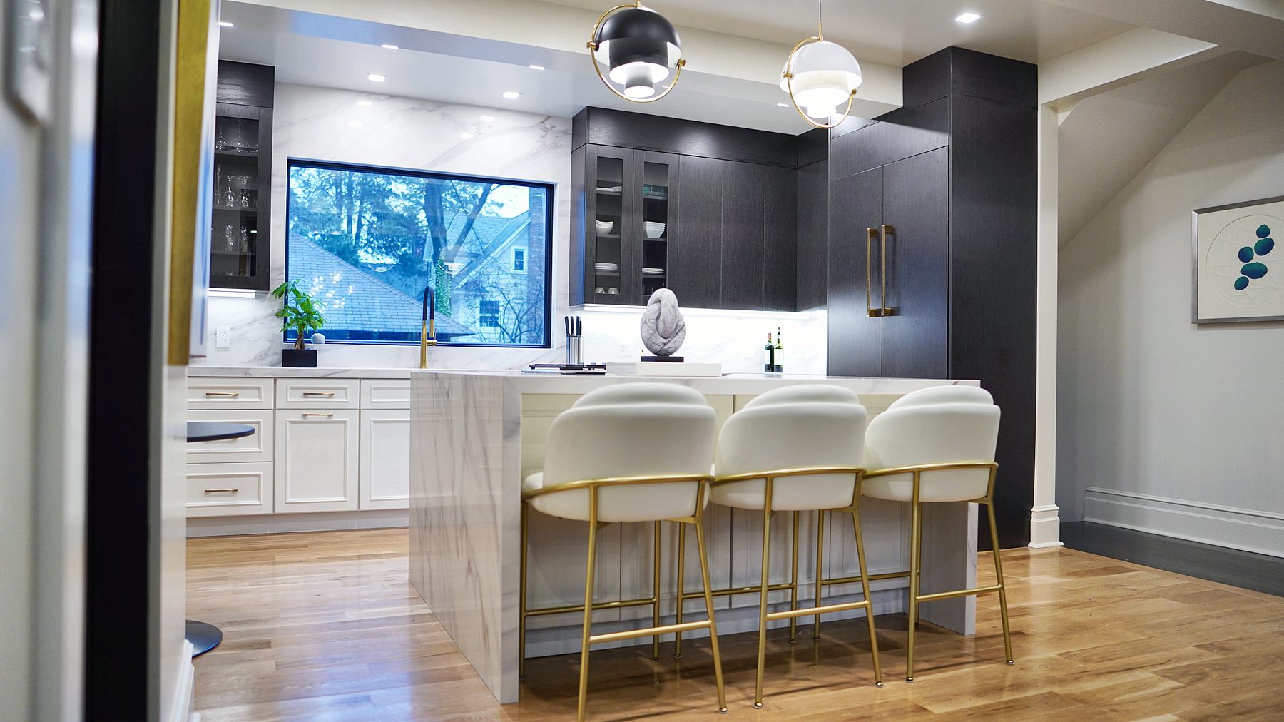Dove raised-panel kitchen with matte black tall cabinets