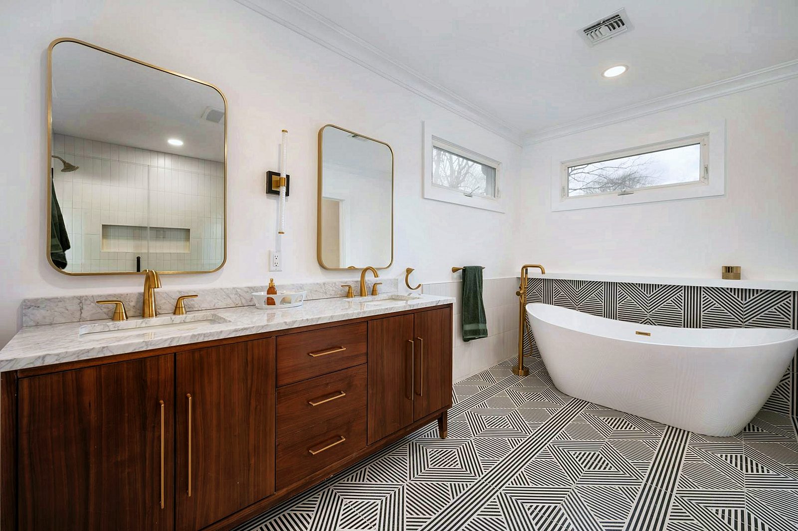 Walnut double vanity with freestanding tub