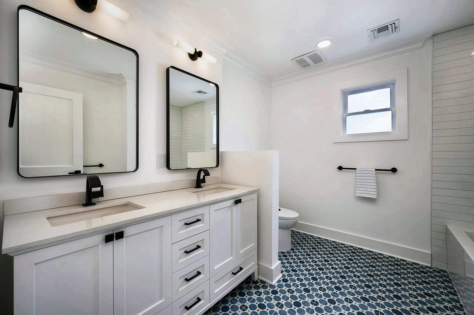 Marble-pattern tile floor and walnut vanity