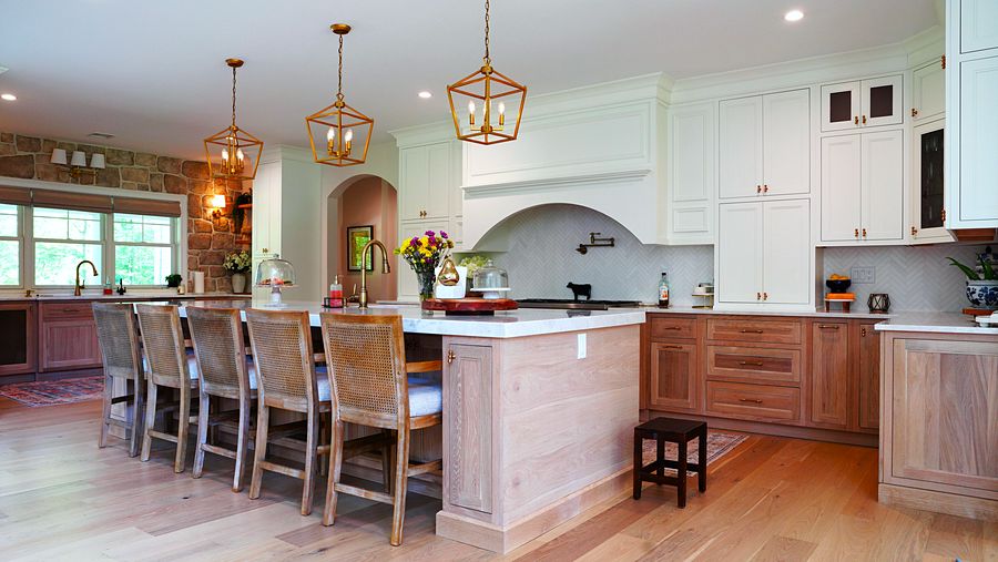 Project 37: Stained wood and white kitchen with an arched hood and a stone wall