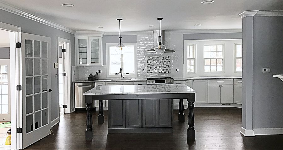 White shaker kitchen with a dark gray furniture-style island in Union, NJ