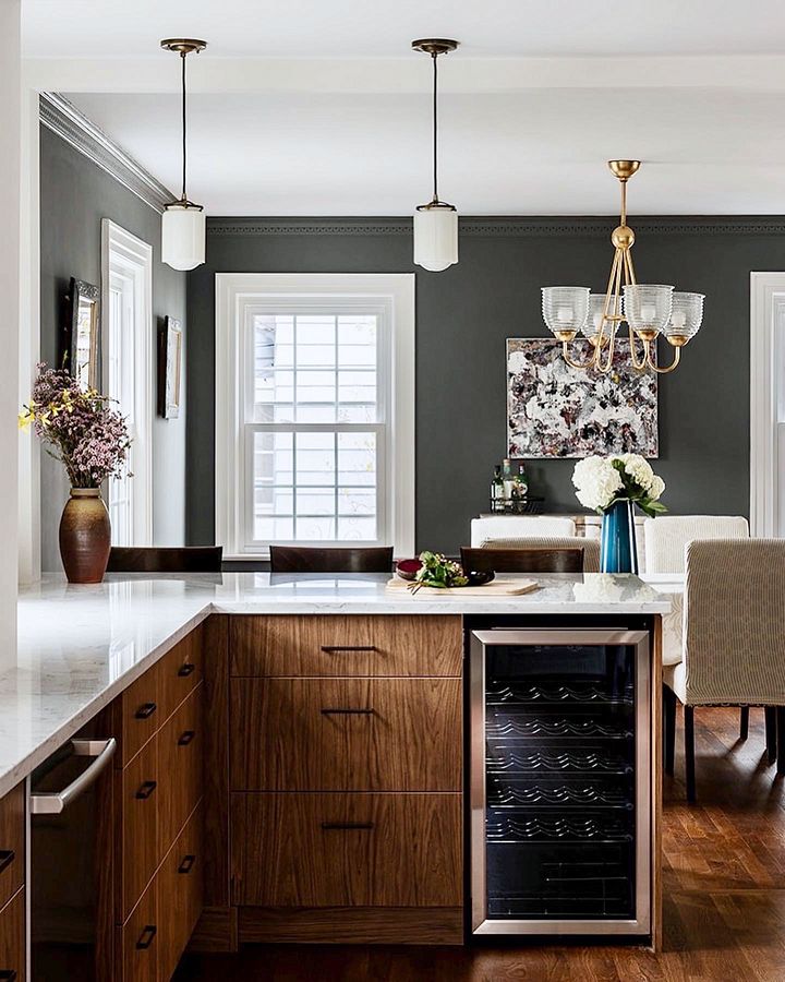 Walnut slab kitchen with marble-look quartz, a farmhouse sink and brass