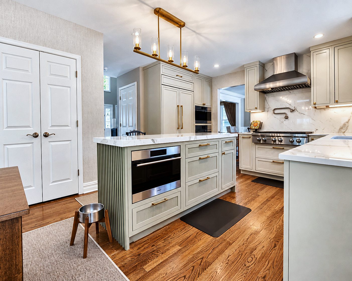 Flush-inset Beige kitchen with reeded Evergreen Fog island and porcelain counters
