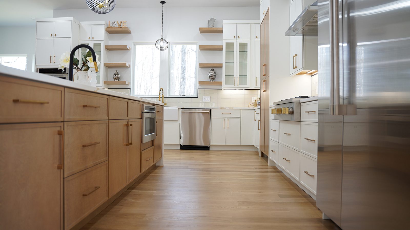Oak island base with brass pulls under the Calacatta-look quartz top