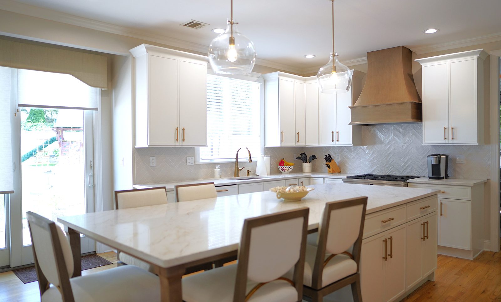 The island and dining table with the wood hood behind