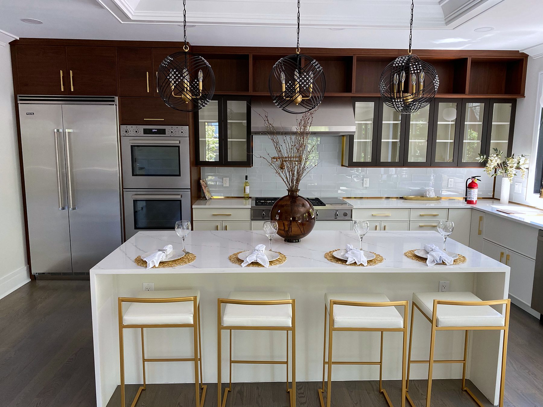White slab and walnut kitchen with a waterfall island