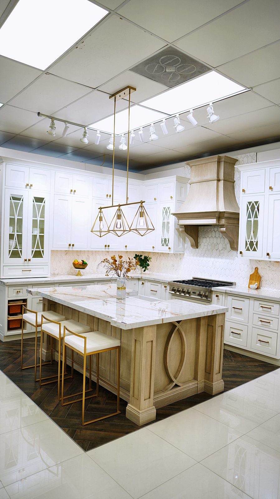 My House Kitchen Union showroom — Traditional white display with island and quartzite top