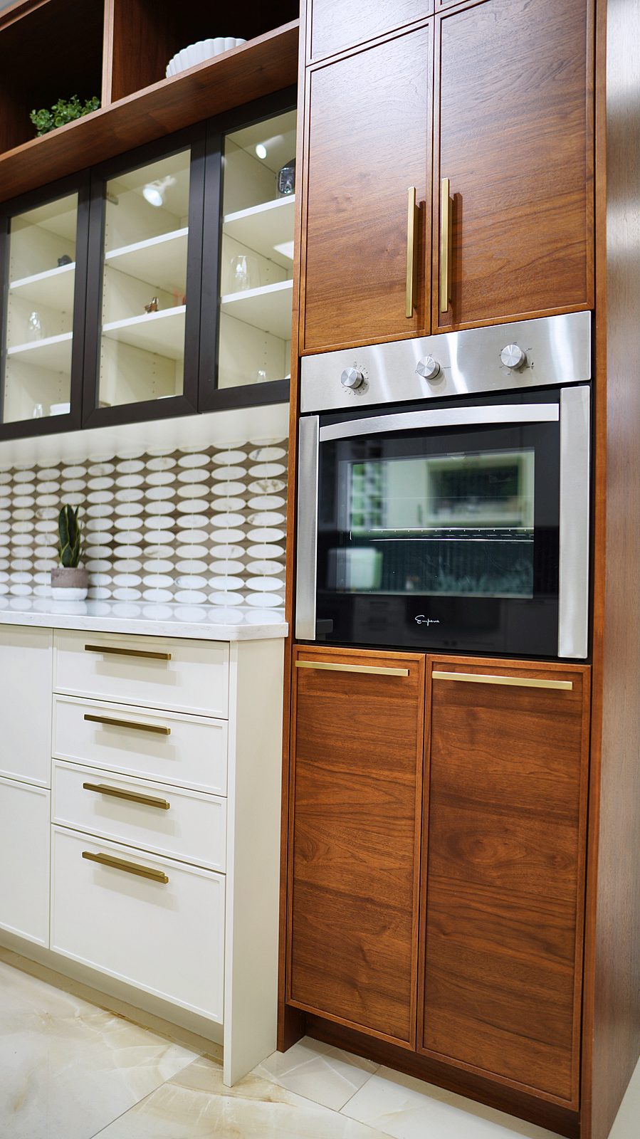 My House Kitchen Union showroom — Walnut tall cabinets with glass uppers